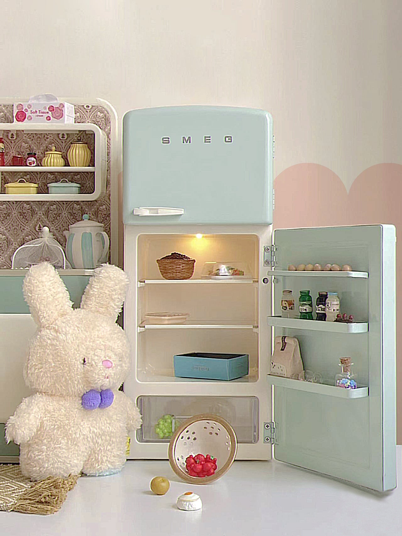 Open mint green dollhouse refrigerator with interior light, plush figure, cabinet and food props not included