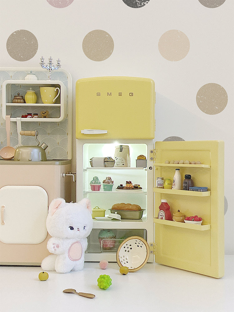Open yellow dollhouse refrigerator with interior light, plush figure and miniature food props not included