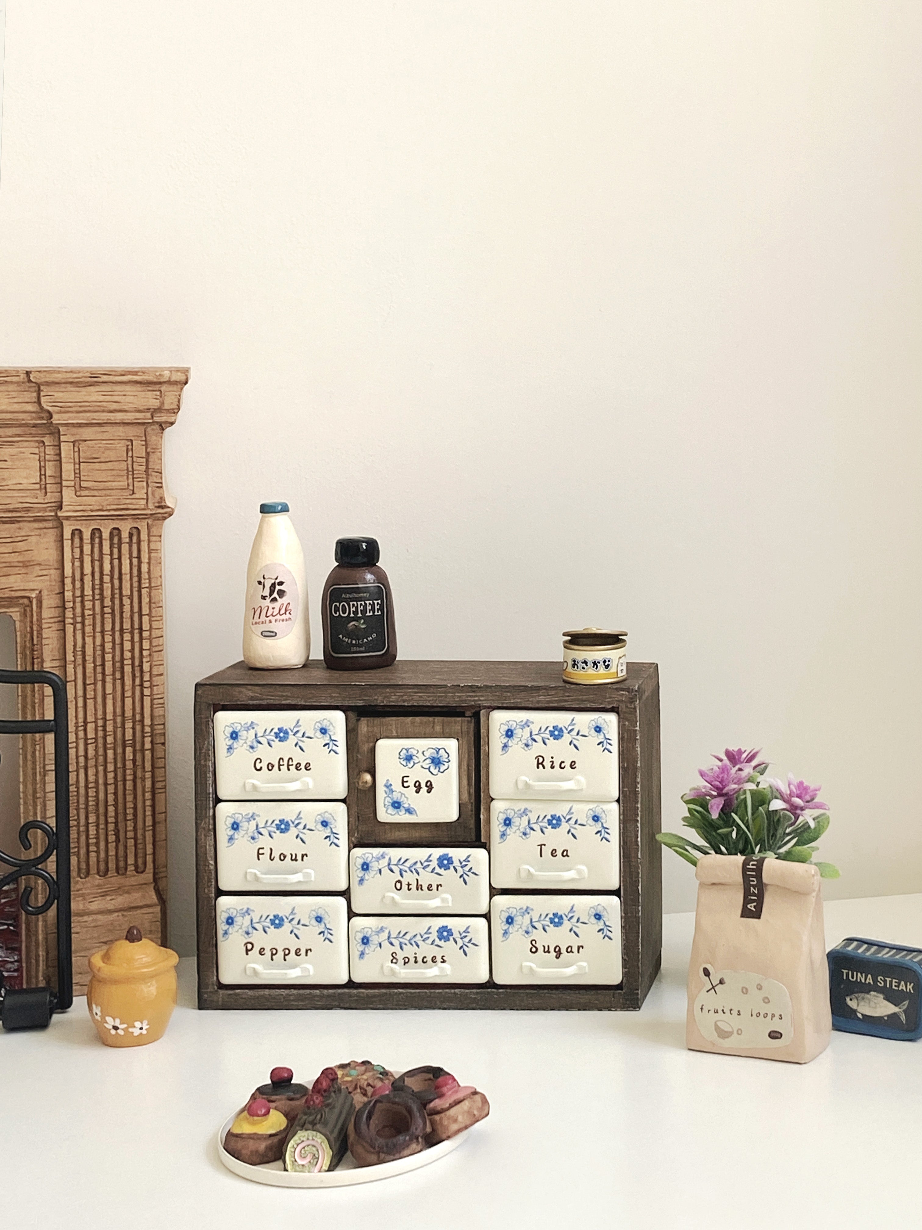 Antler Brown spice cabinet styled in dollhouse kitchen scene with food props and warm wood furniture

